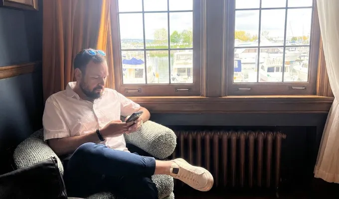 Kevin Edry by a marina window