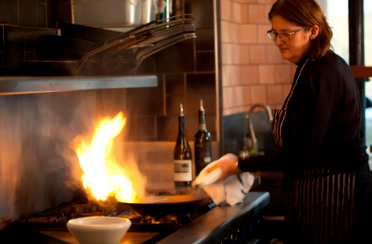 A pan flaming on the line in the Terra Plata kitchen
